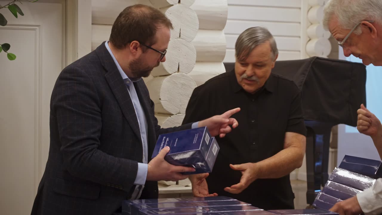 Guests laughing and holding new Bibles at the giveaway event
